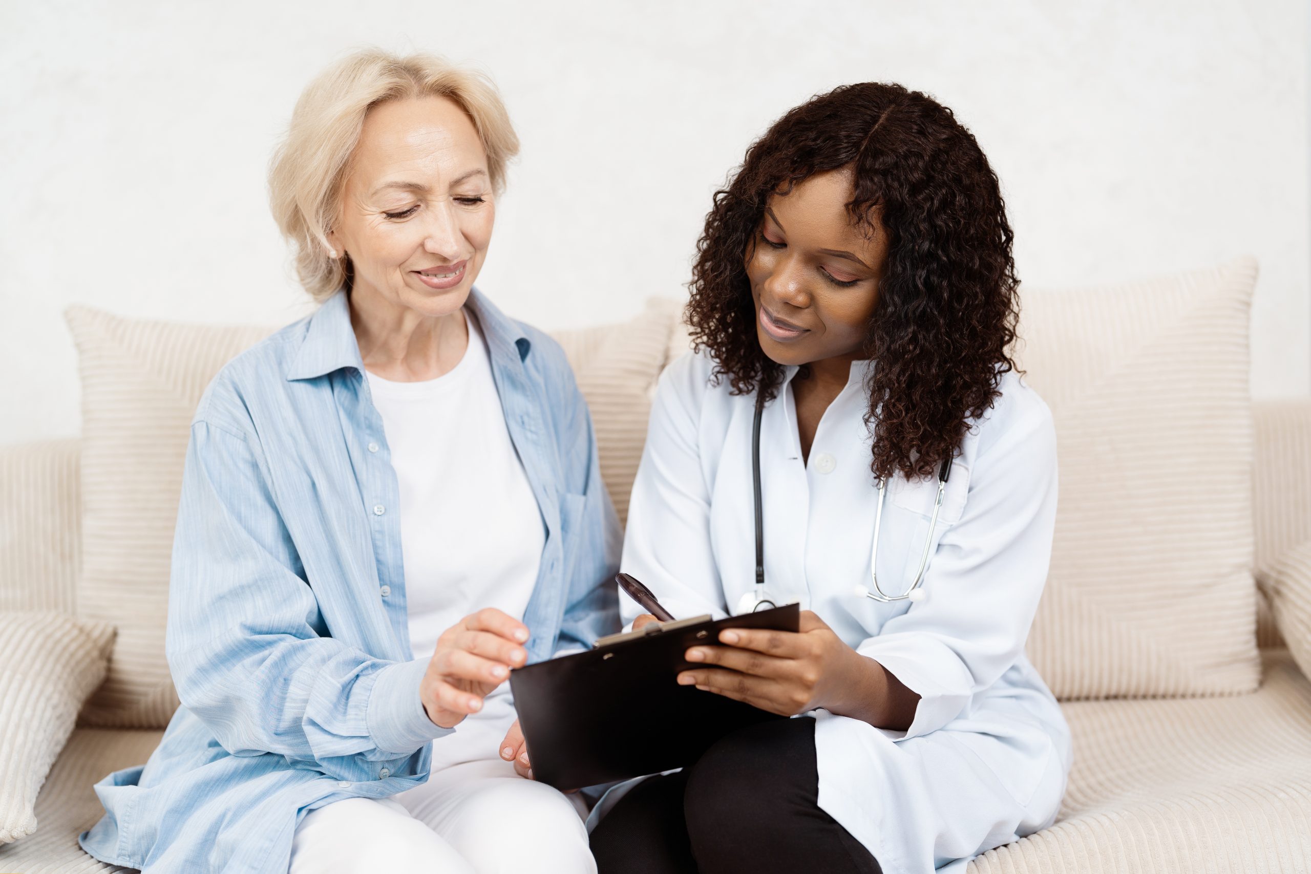 Doctor Consulting Senior Woman Patient at Home in a Friendly Environment