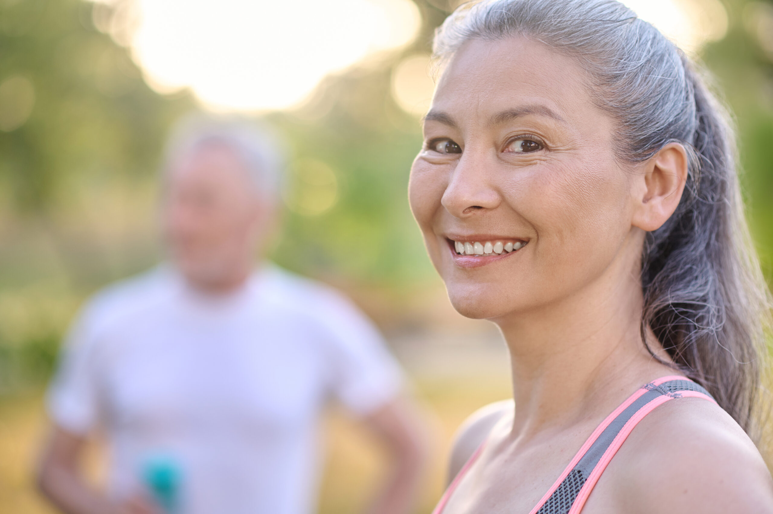 A mature, happy woman smiles at the camera—she has been using her Marodyne Liv after experiencing a fall and has had faster recovery as a result.